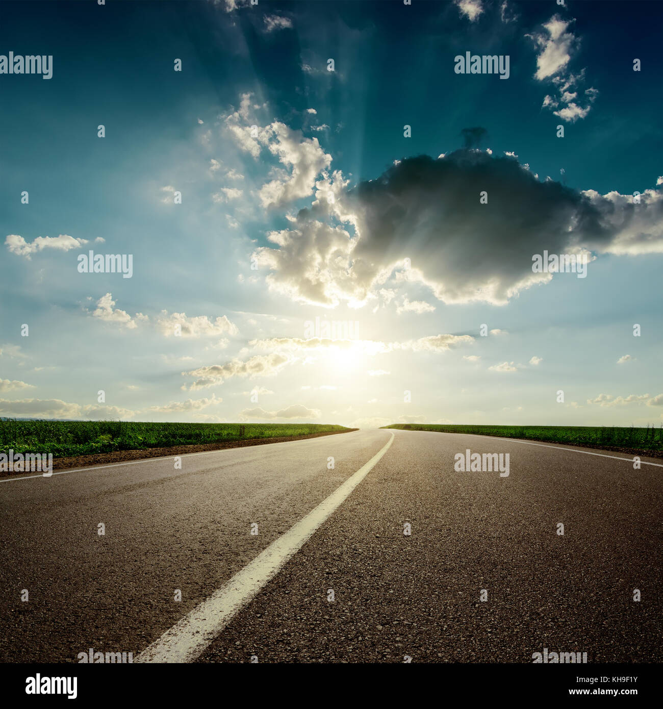 dramaric sunset over asphalt road closeup Stock Photo - Alamy