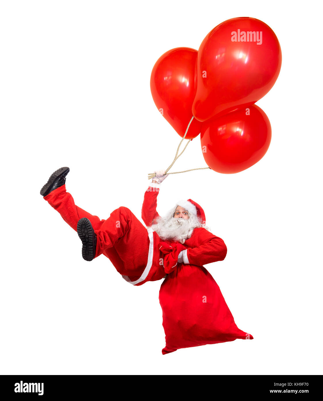 Funny flying Santa Claus falls with a bag full of x-mas gifts. Falling Santa holds air ballons isolated on white background. Santa Claus hover with ba Stock Photo