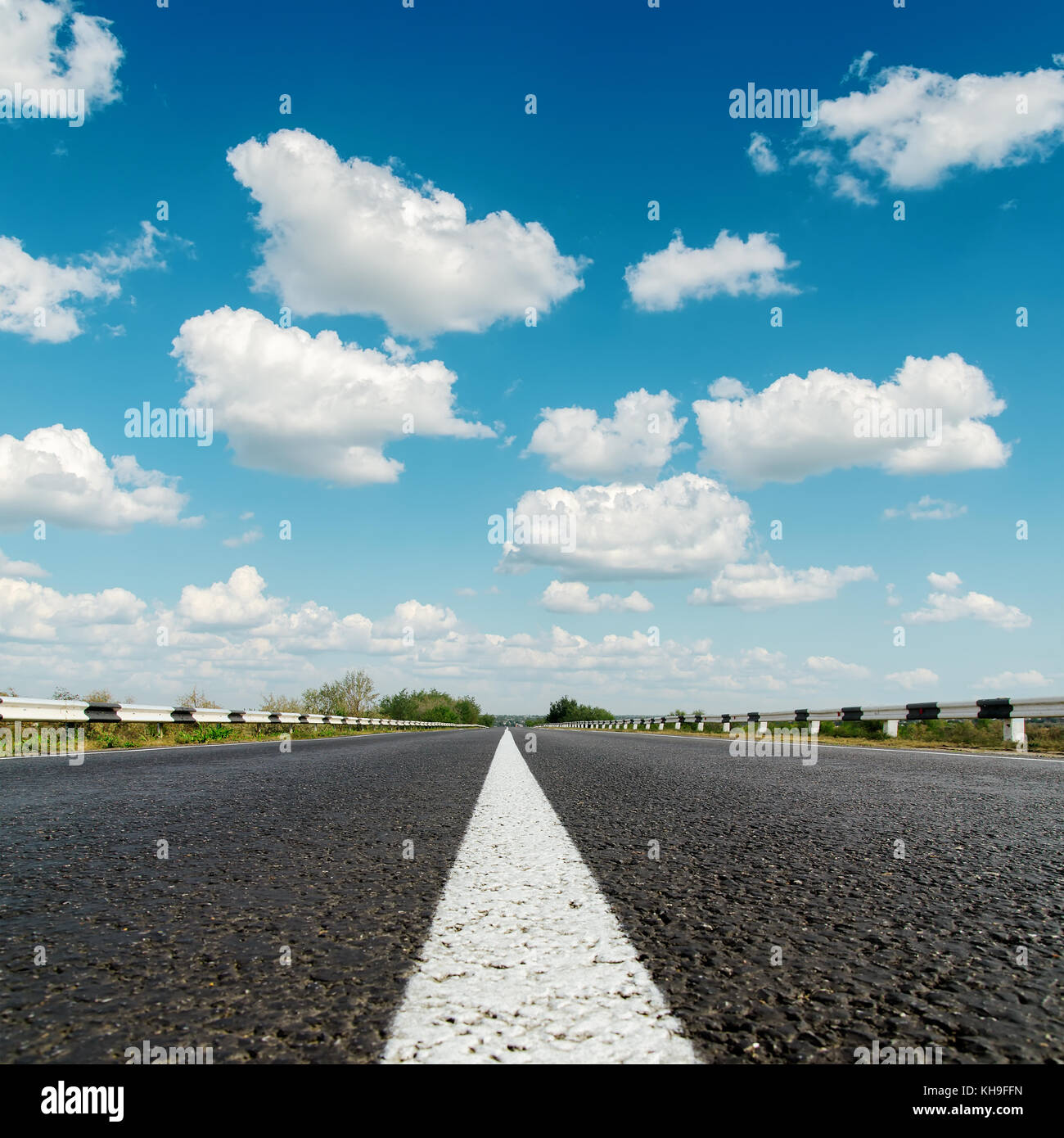 asphalt road under blue cloudy sky Stock Photo - Alamy