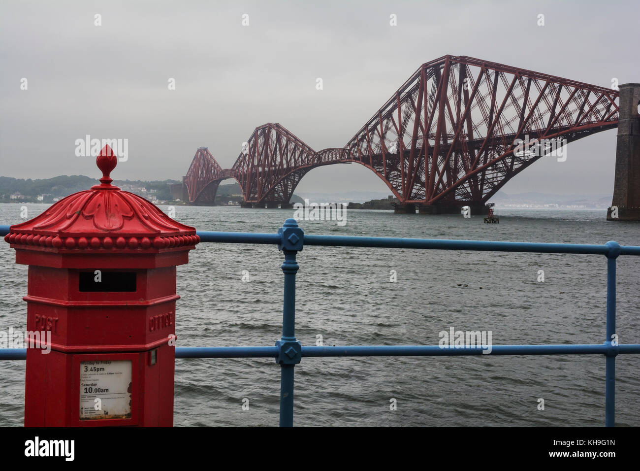 The Forth Rail Bridge, Edinburgh, with a Victorian Penfold pillar box in the foreground Stock Photo