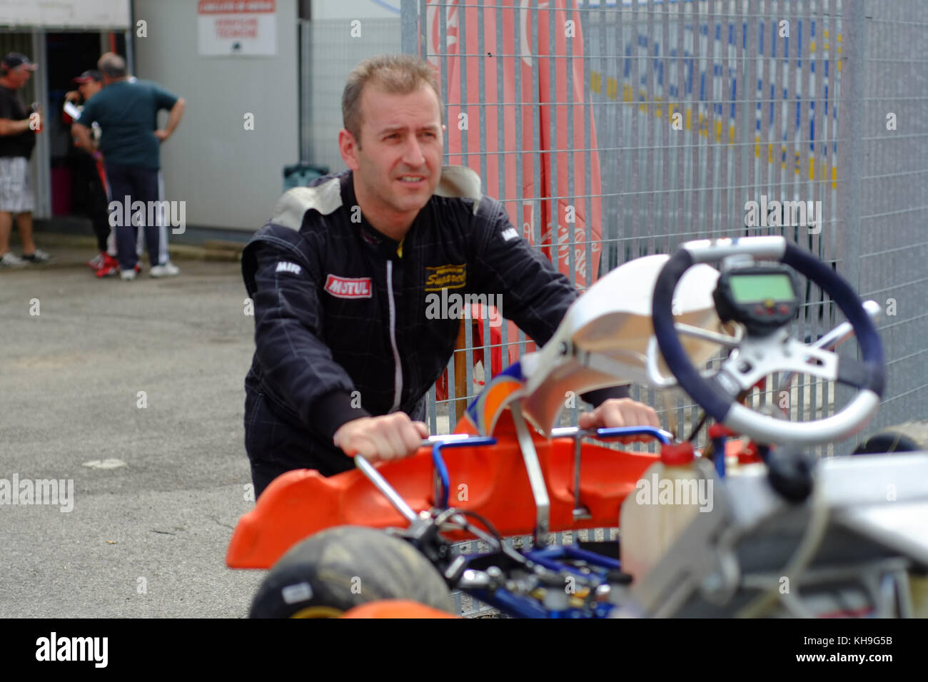 Mature driver man in the box area. Gokart regional championship race ...