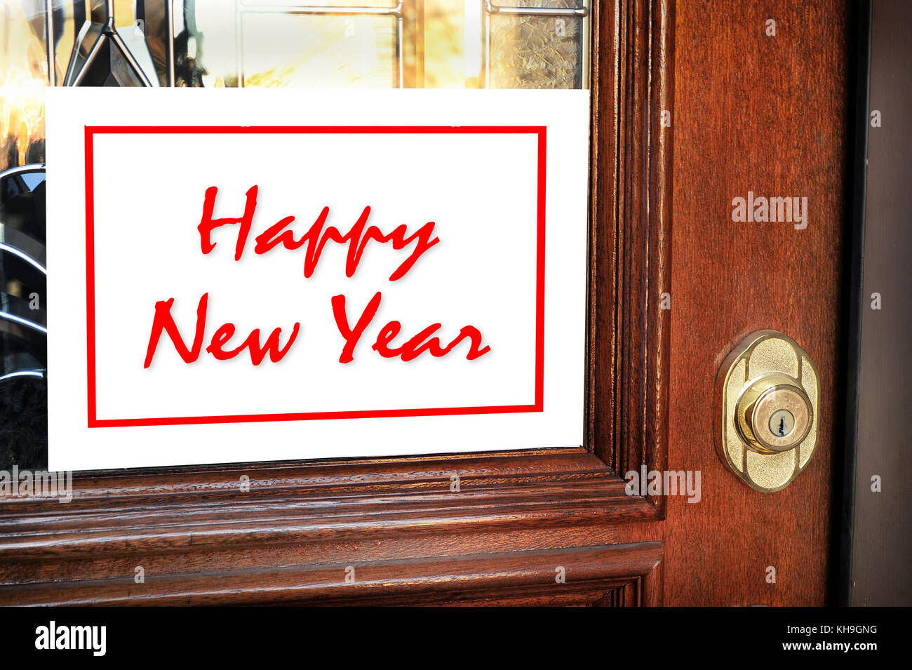 Happy New Year sign on home front door. Stock Photo