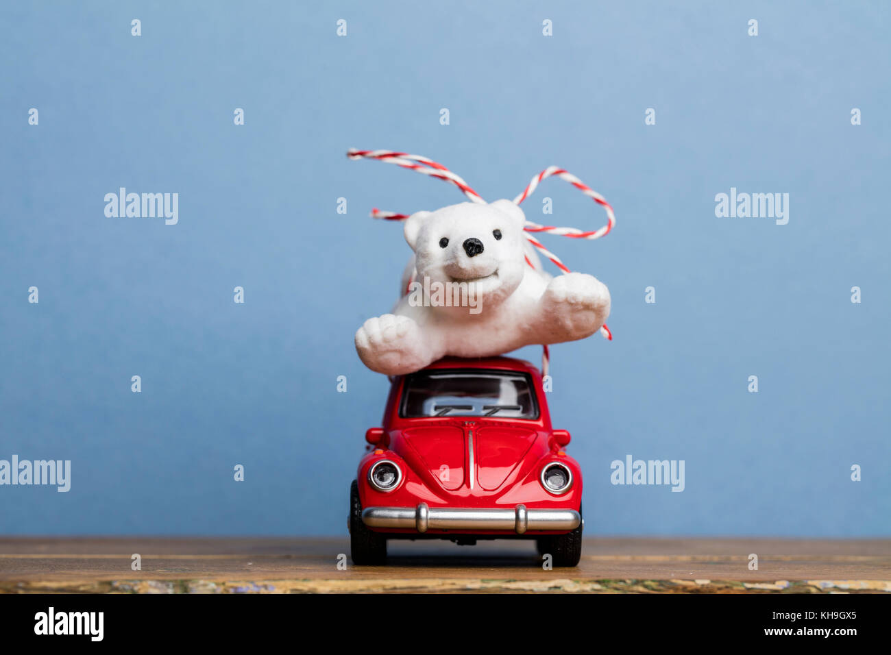 LONDON, UK - DECEMBER 15th 2016: Christmas background concept with red toy car aginst blue background Stock Photo