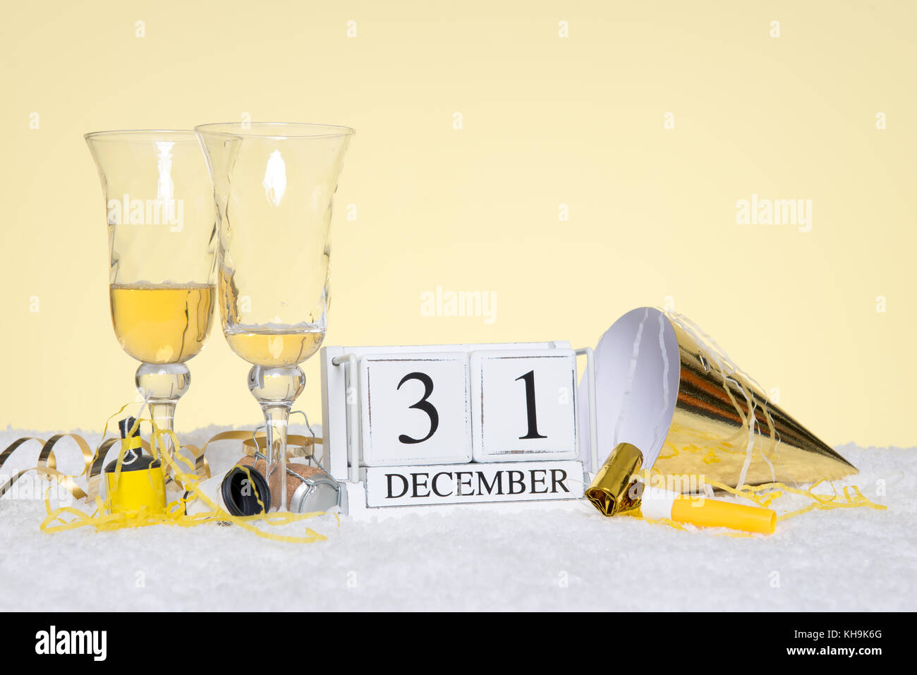 New Year party still life with two empty glasses of Champagne and a date block showing 31st December with streamers. Copy space on the background for  Stock Photo