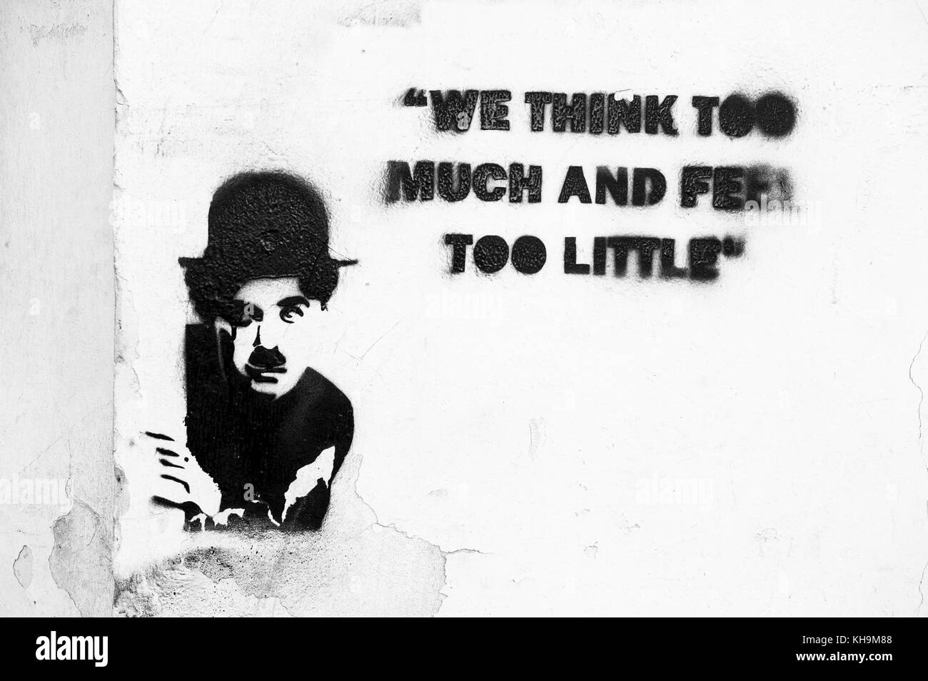 Quote by Charlie Chaplin: ' We think too much and feel too little', writting on a wall in Krems an der Donau, Lower Austria, Austria, Europe Stock Photo