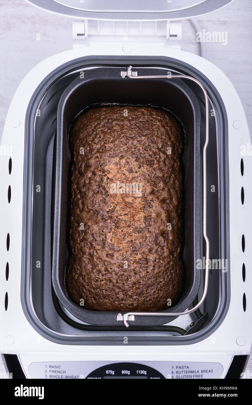 Homemade cocoa cake with walnuts and raisins baked in bread maker. Stock Photo