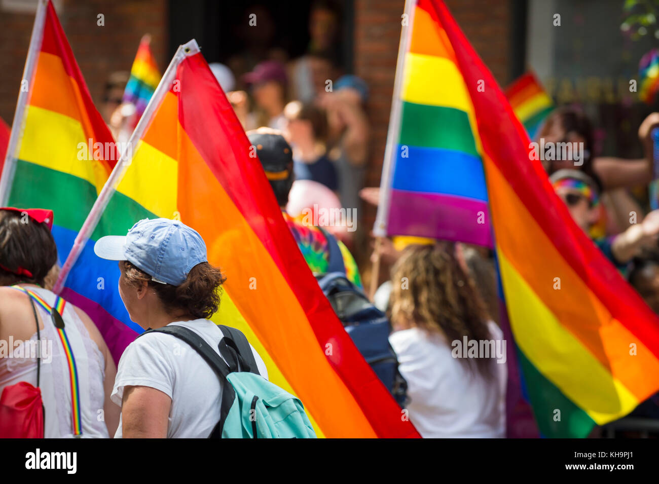 NEW YORK CITY - JUNE 25, 2017: Supporters wave rainbows flags on the sidelines of the annual Pride Parade as it passes through Greenwich Village. Stock Photo
