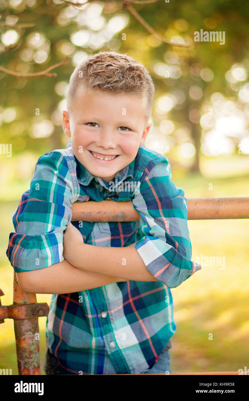 young boy in a rural setting wearing plaid shirt portrait Stock Photo