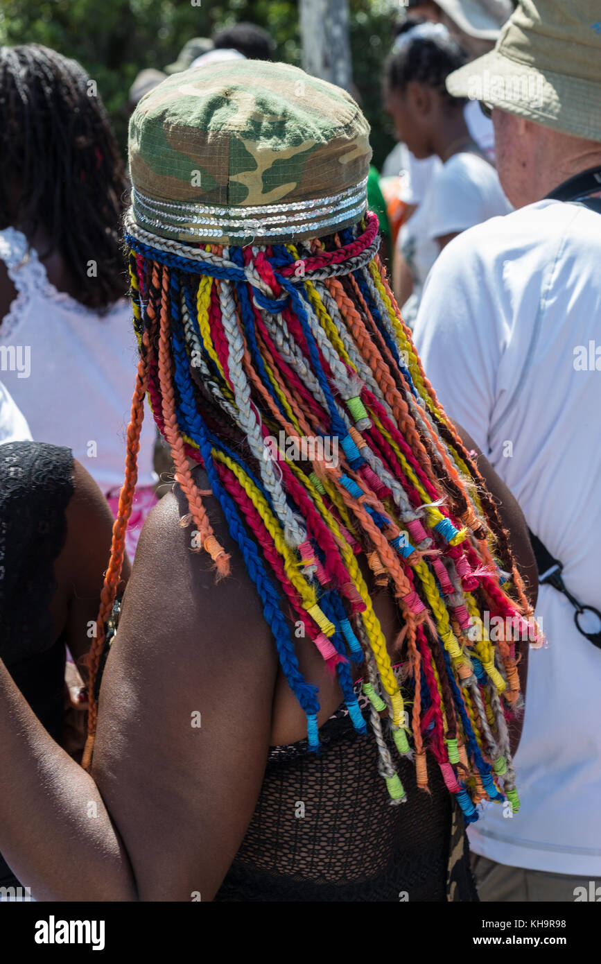 A native woman with colorful braids of hair at a Zebu sacrifice ceremony, Lake Ampitabe, Toamasina, Madagascar, Africa Stock Photo