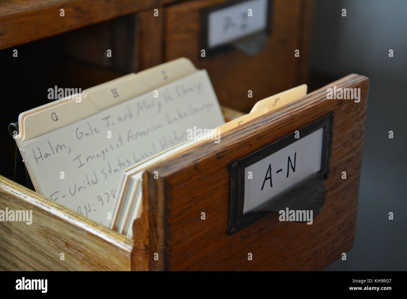 A handwritten antique person library paper and wooden card catalog ...