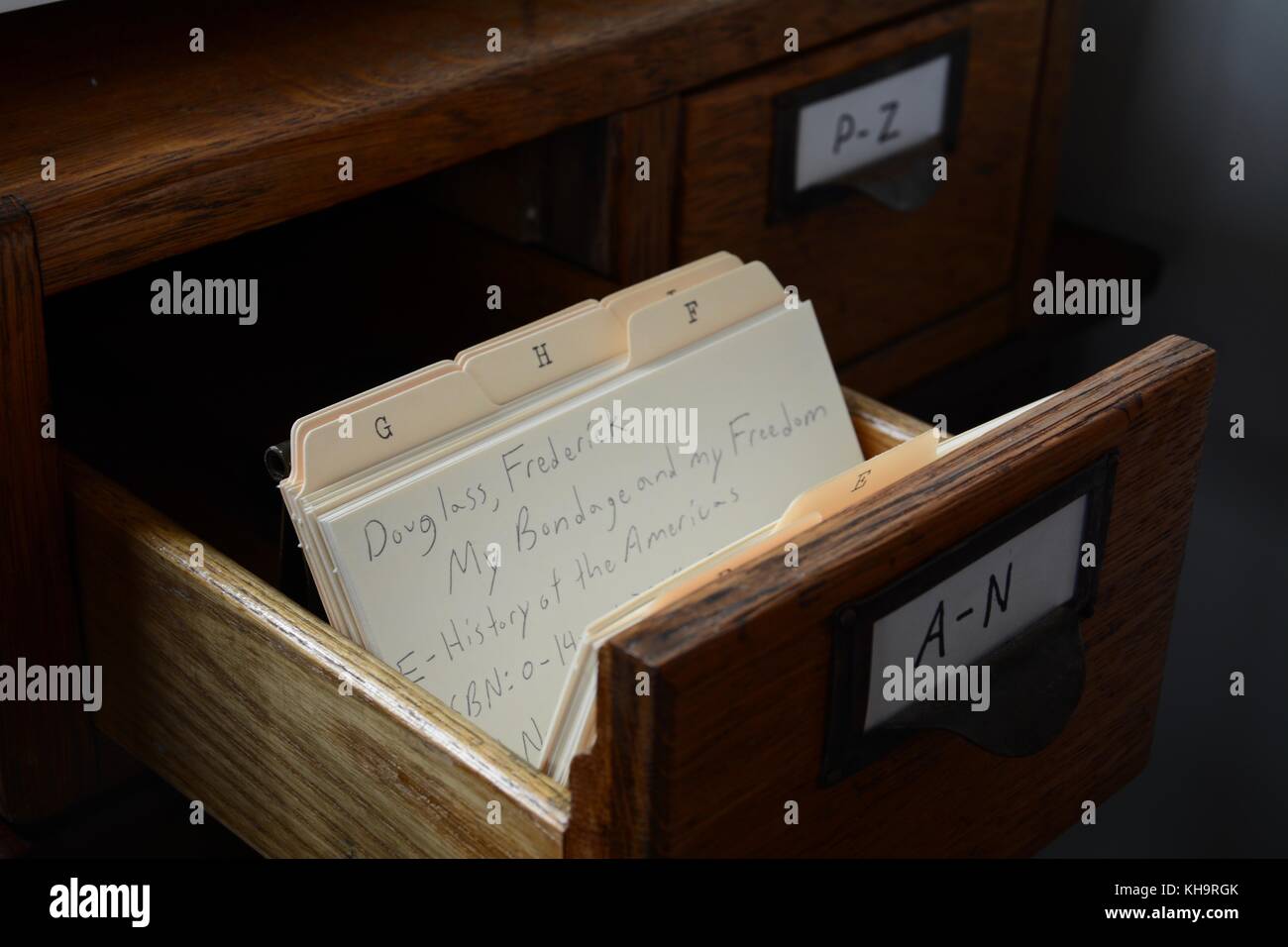 A handwritten antique person library paper and wooden card catalog ...