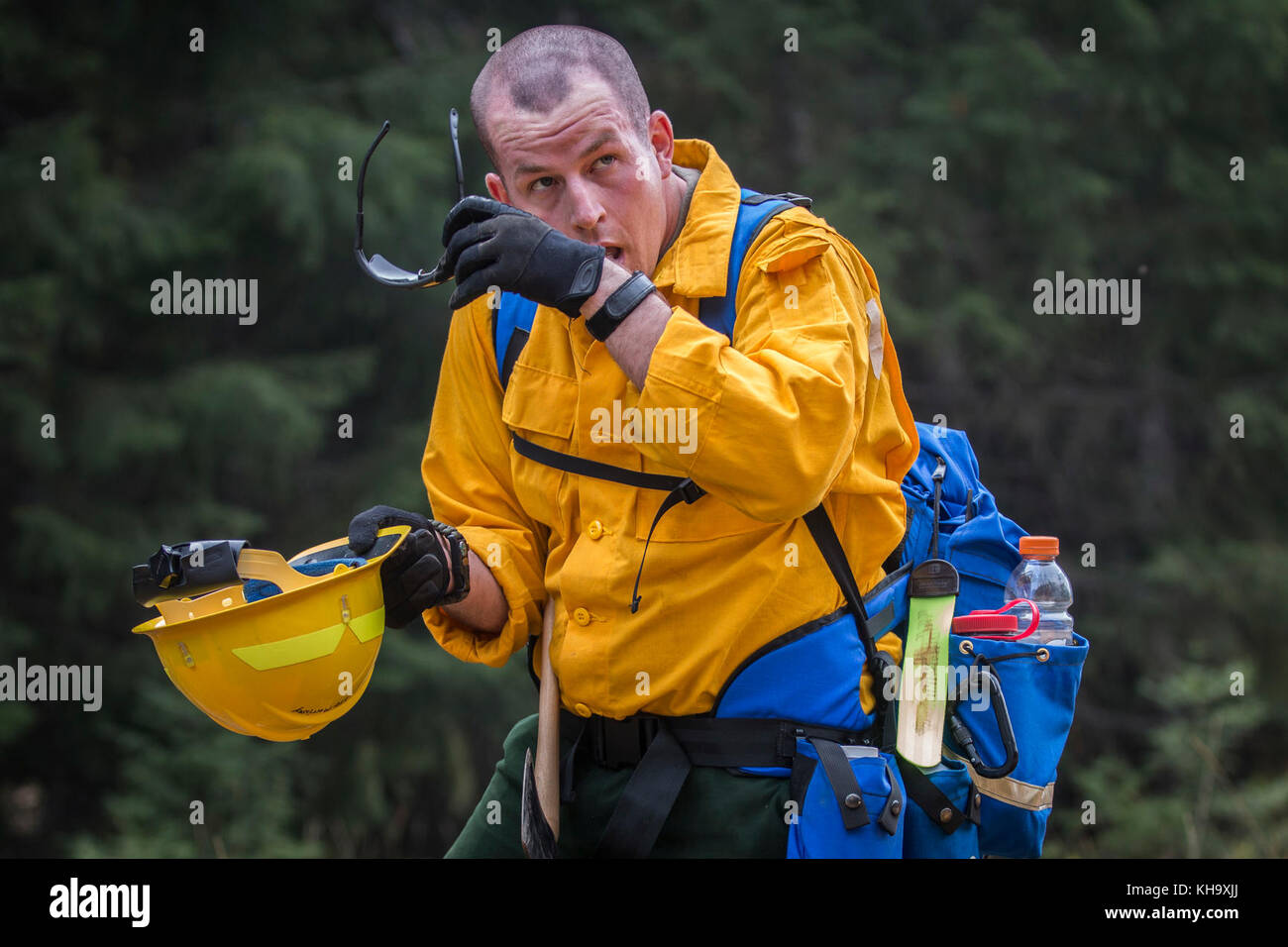 A U.S. Army Soldier, assigned to 23rd Brigade Engineer Battalion, 1-2 Stryker Brigade Combat Team, pauses to wipe the sweat from his brow during initial tactical training with civilian firefighters working with the U.S. Forest Service in the Umpqua National Forest, Umpqua North Complex, Oregon, Sept. 8. The training will prepare the Soldiers with the skills necessary to safely and effectively assist firefighter in the containment of the wild fires currently active in the Pacific Northwest. (U.S. Army photos by Pvt. Adeline Witherspoon, 20th Public Affairs Detachment) Stock Photo