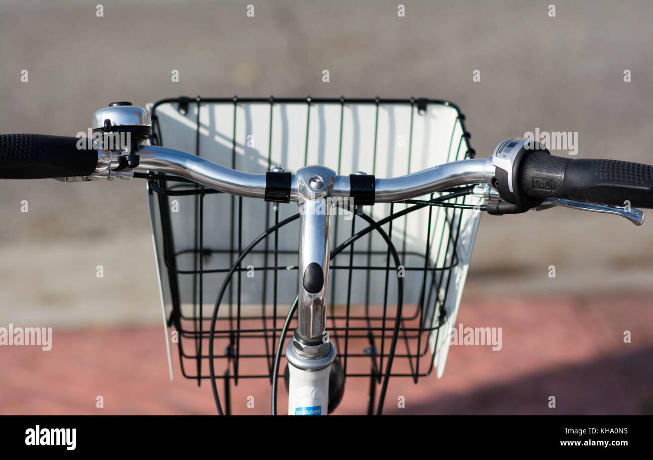 a set of bicycle handle bars with bell and a basket. Stock Photo
