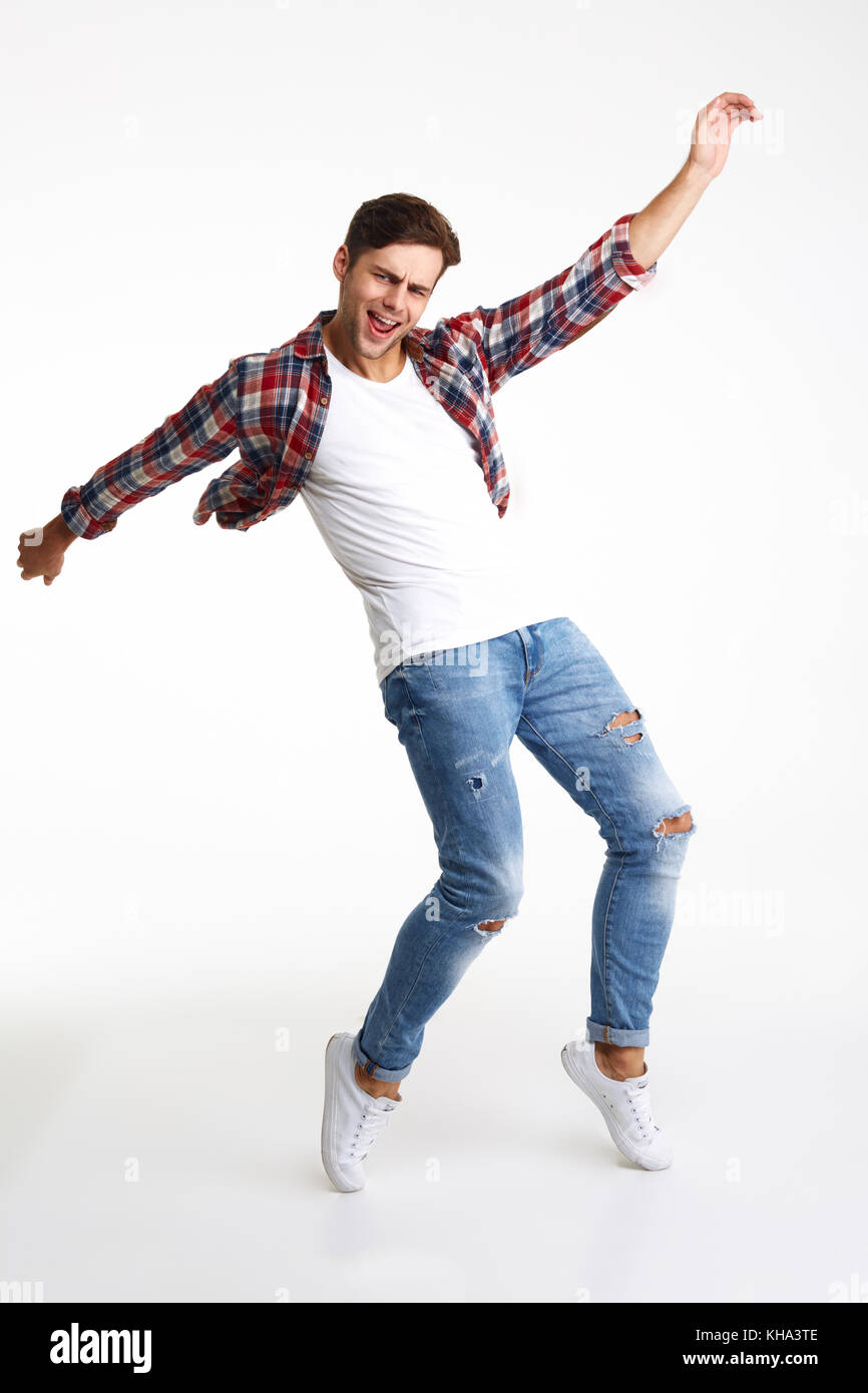 Full length portrait of an eaxcited happy man standing on his tiptoes and  with hands outstretched isolated over white background Stock Photo - Alamy