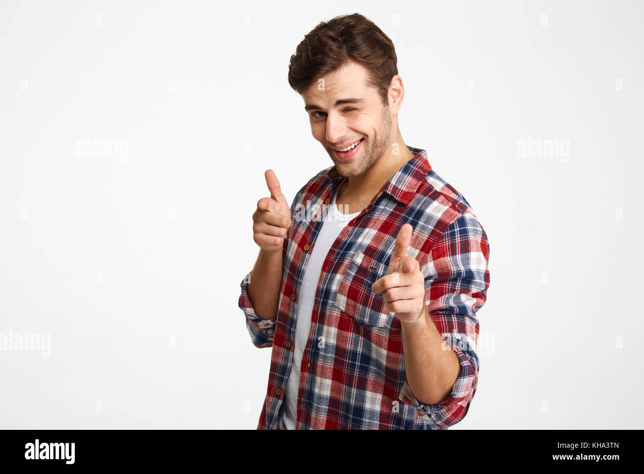 Portrait of cheeky cute young girl in t-shirt, wink and smiling, pointing f...