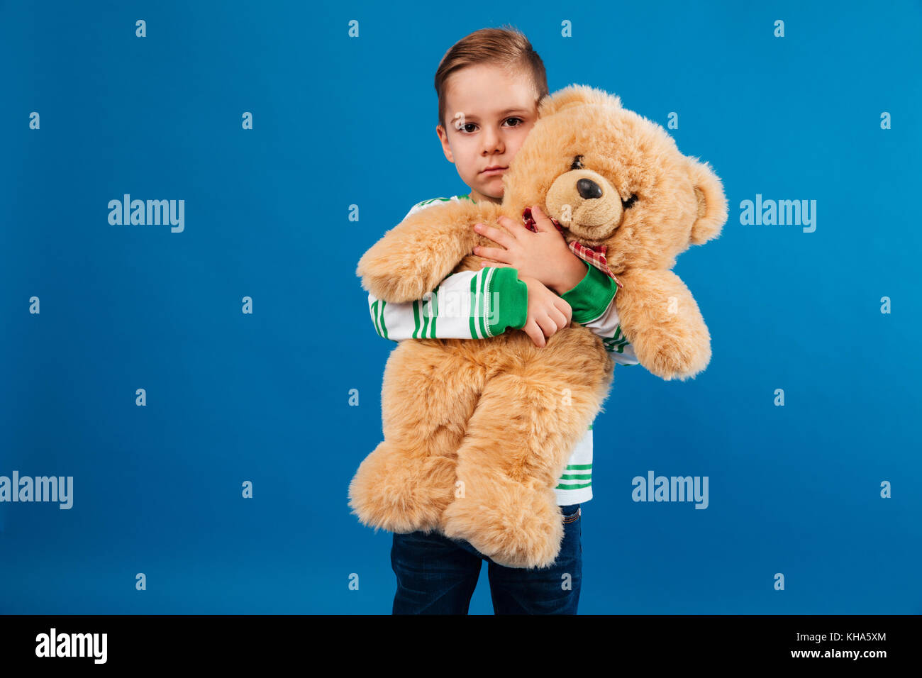 Boy hugging teddy bear hi-res stock photography and images - Alamy