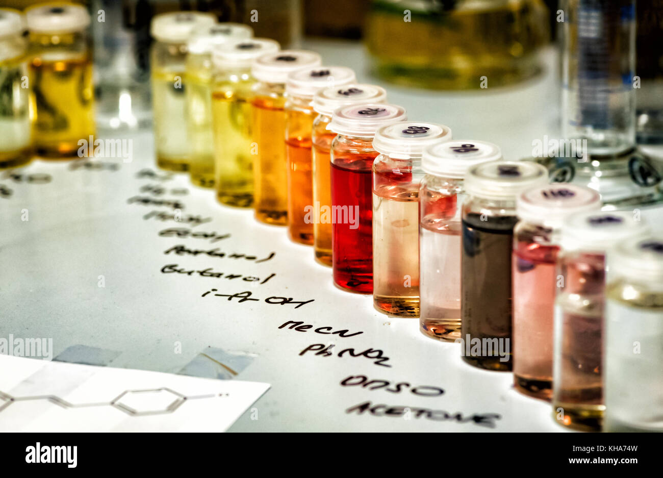 Glass chemistry containers filled with different chemicals Stock Photo