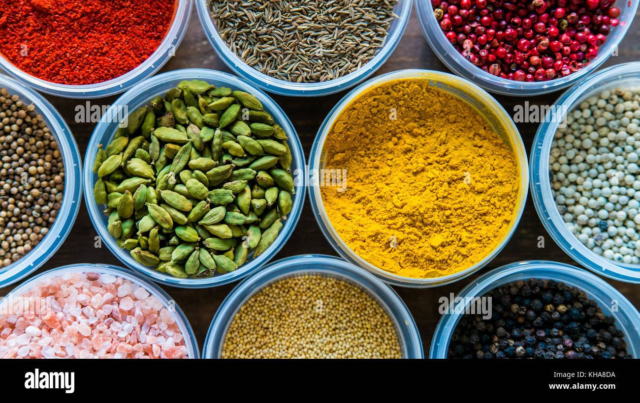 Various colorful spices in plastic containers Stock Photo Alamy