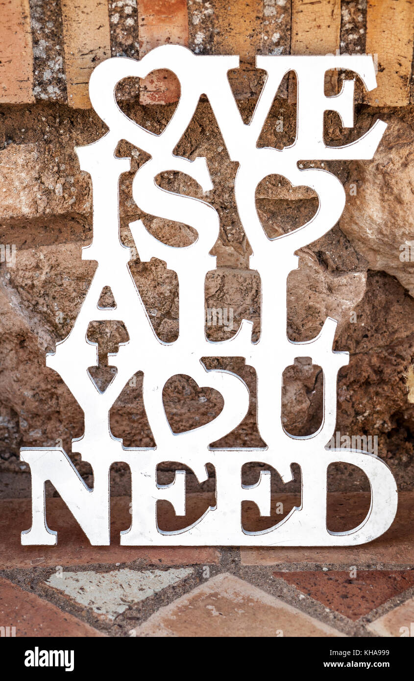 Love is all you need sing over rustic ground. Vintage decoration for weddings Stock Photo