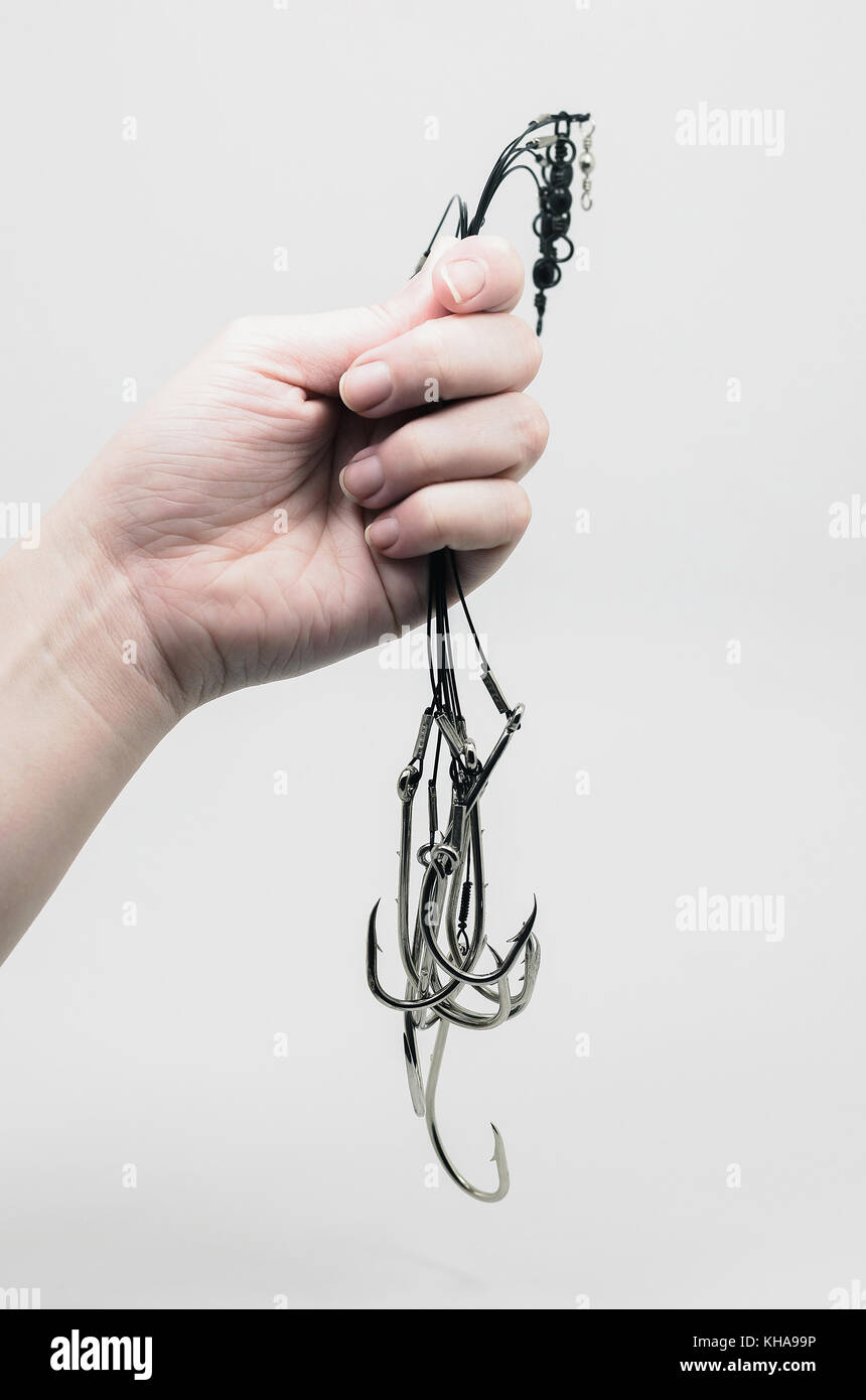 Hand holding a bunch of fishing hook link ready made, tied on the steel  cable with rolling barrel. Fishing accessory ready for fishing isolated on  whi Stock Photo - Alamy