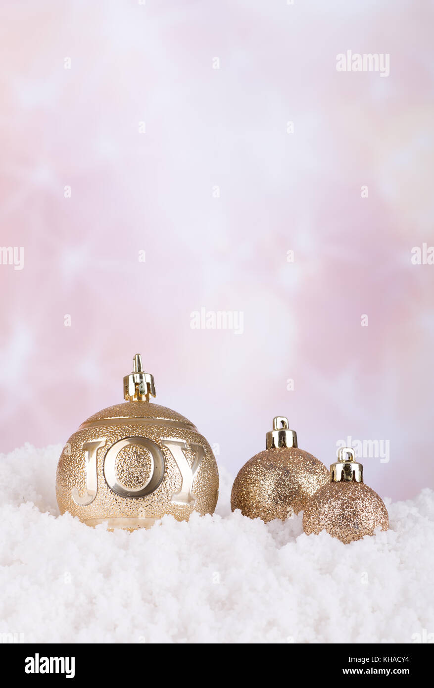Gold Christmas ornaments on snow with colorful background Stock Photo ...