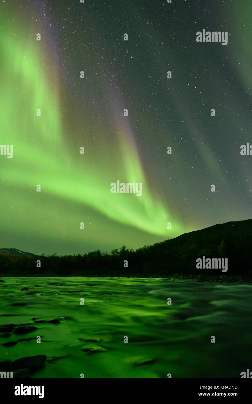 Northern lights over the river Aisko in Abisko National Park, Sweden Stock Photo