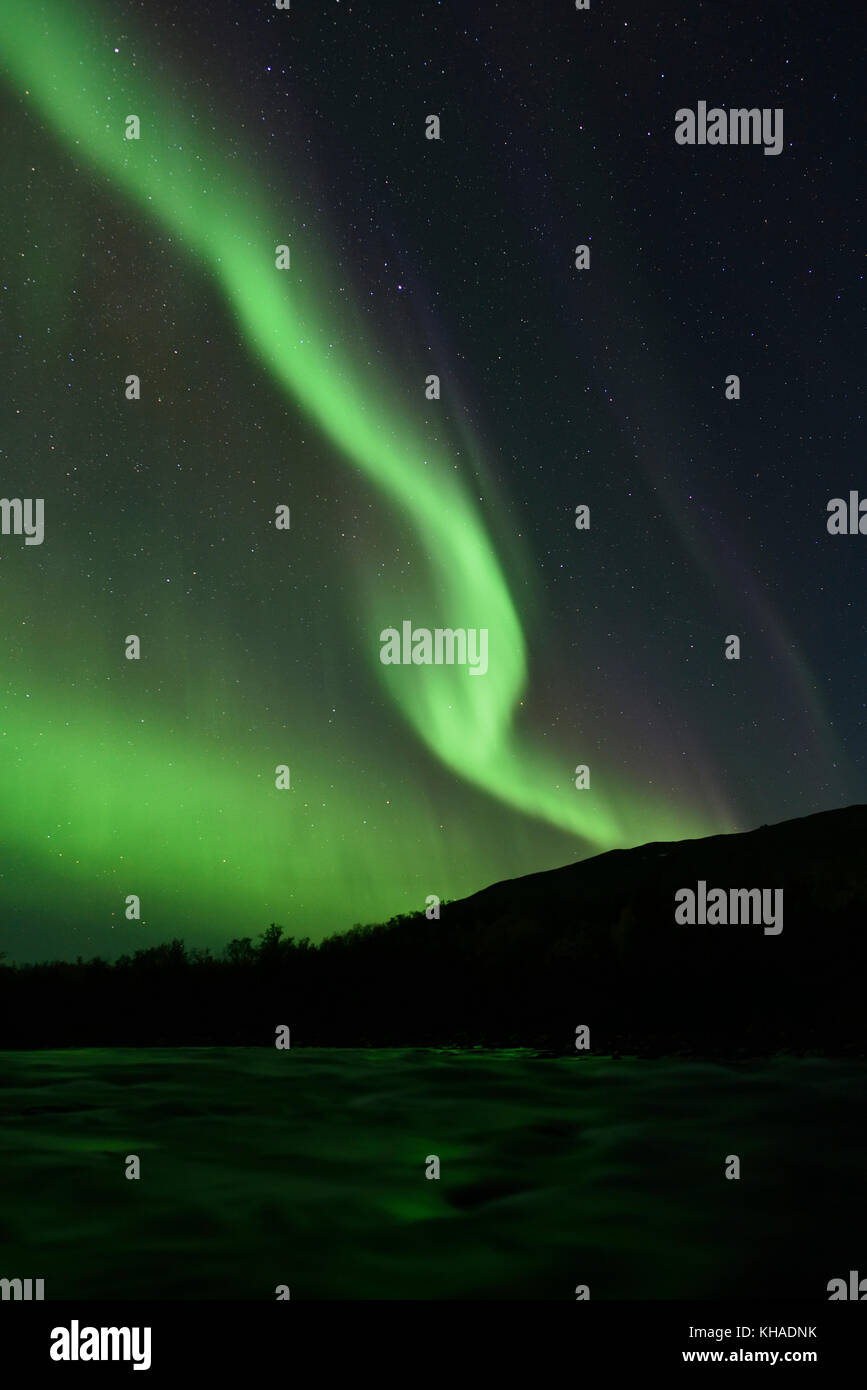 Northern lights over the river Aisko in Abisko National Park, Sweden Stock Photo