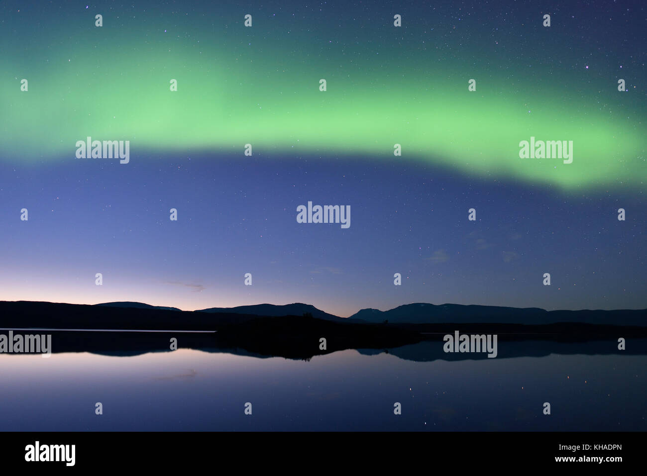 Northern lights over a lake in the Abisko National Park, Sweden Stock Photo