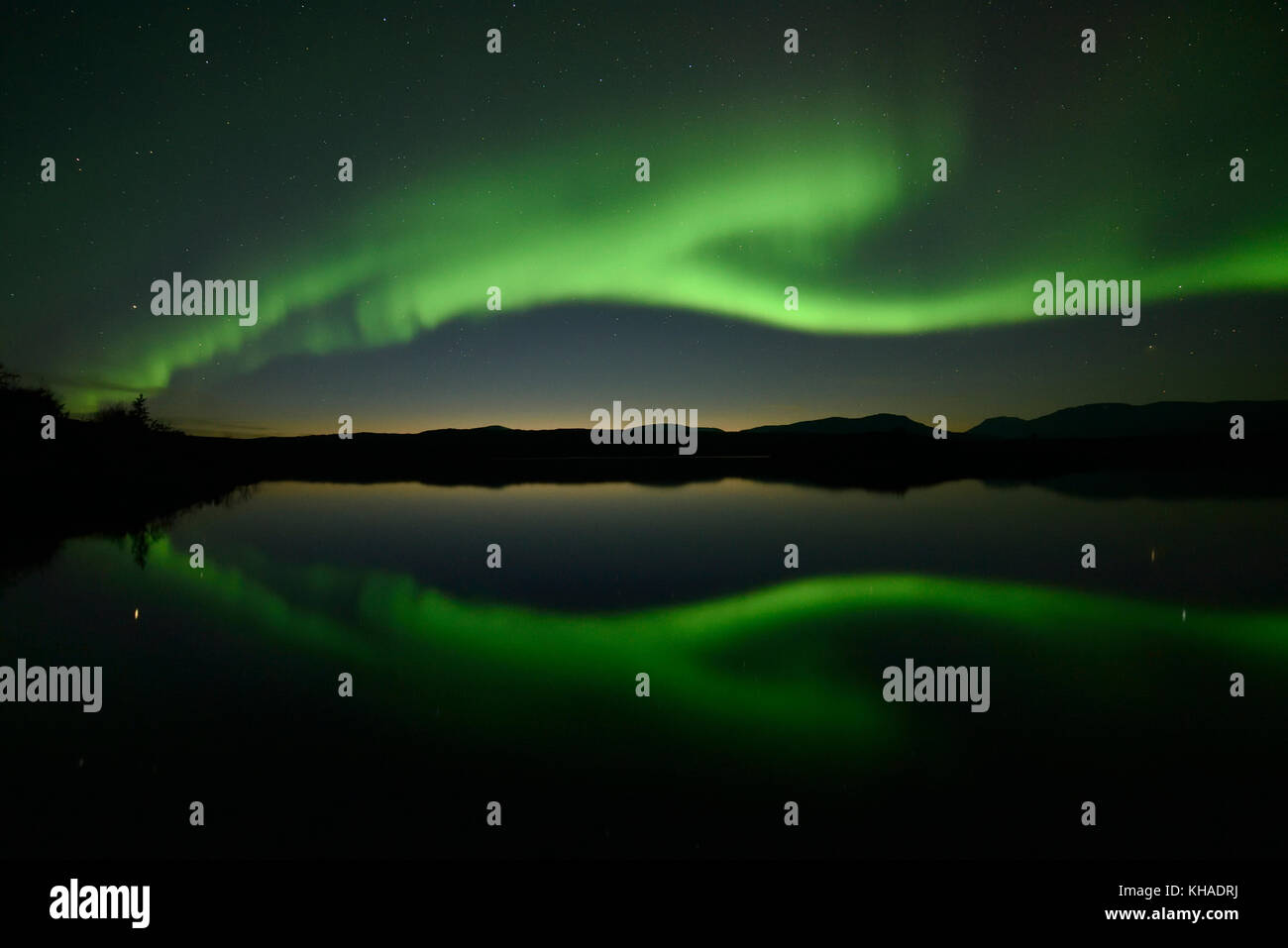 Northern lights reflected in a lake in the Abisko National Park, Sweden Stock Photo