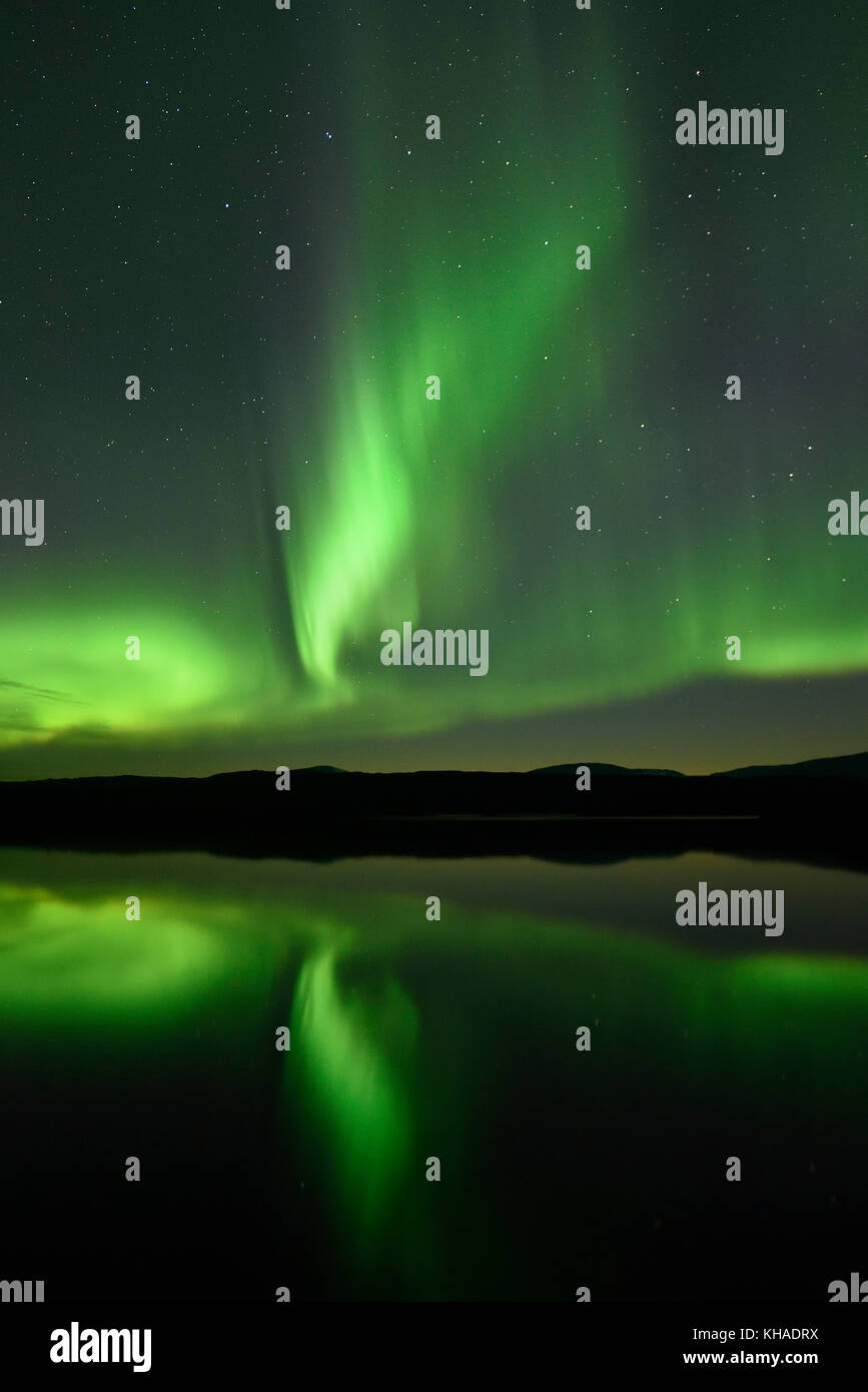 Northern lights reflected in a lake in the Abisko National Park, Sweden Stock Photo