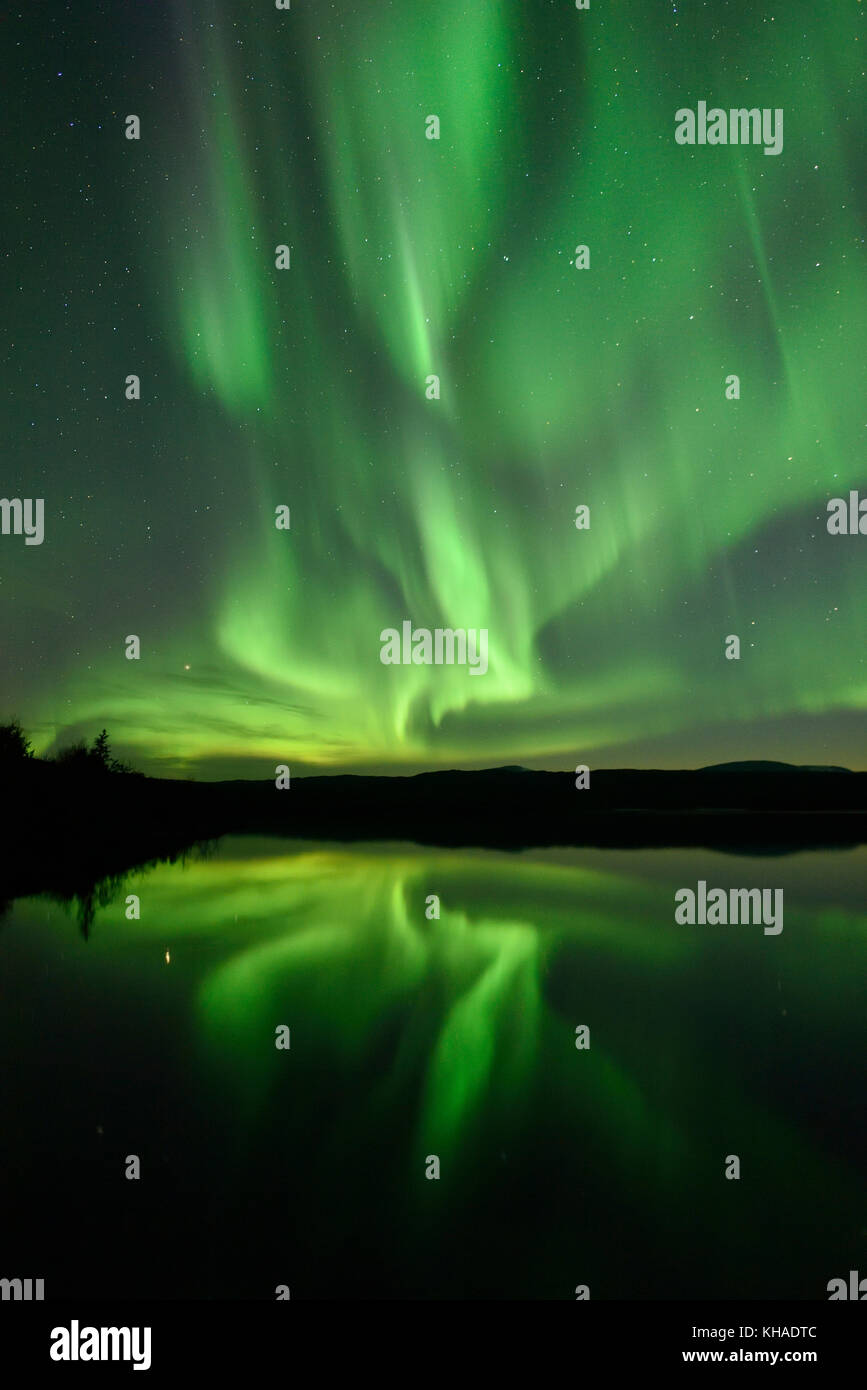 Northern lights reflected in a lake in the Abisko National Park, Sweden Stock Photo