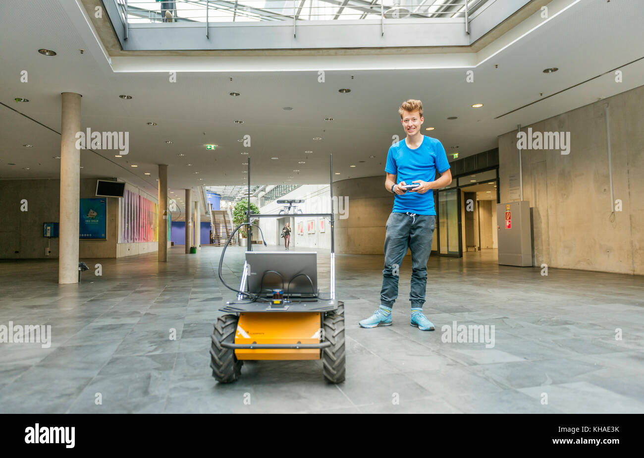 Student with robot Auto Husky of the company Clearpath, autonomic driving, University of Applied Sciences Munich, Bavaria Stock Photo