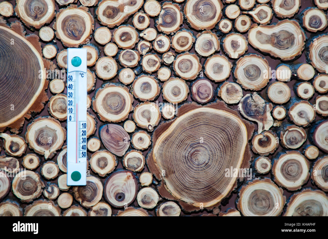 Wood thermometer calibrated in degrees celsius on the wooden wall, Stock Photo