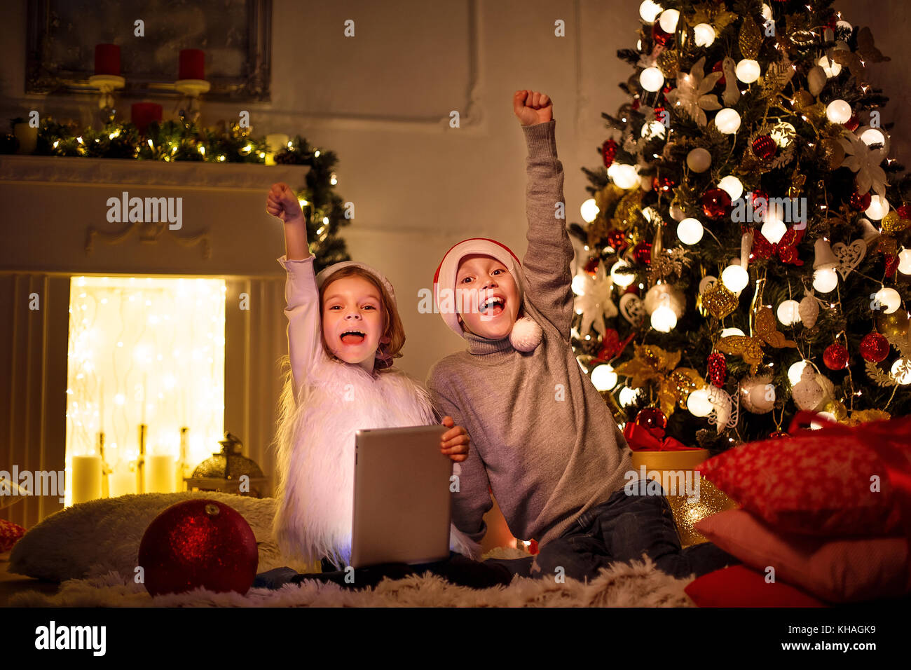Excited children near Christmas tree Stock Photo