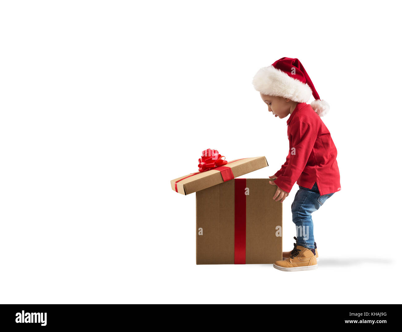 Child that open a magic Christmas gift. White background Stock Photo