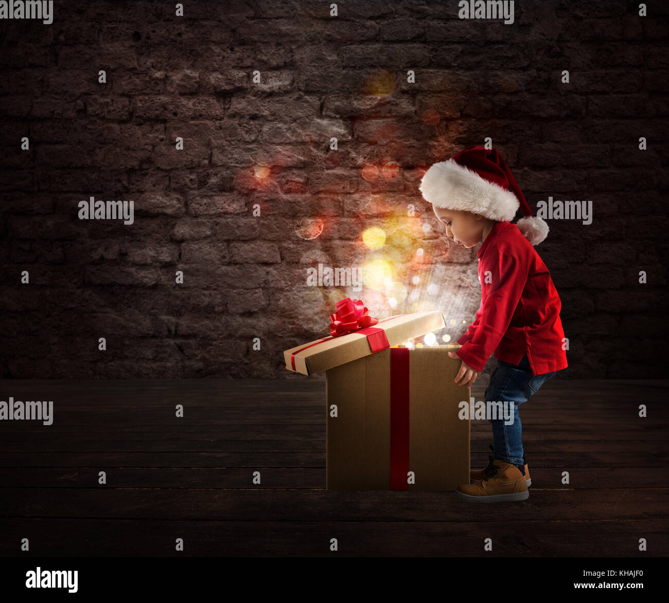 Child that open a magic Christmas gift Stock Photo
