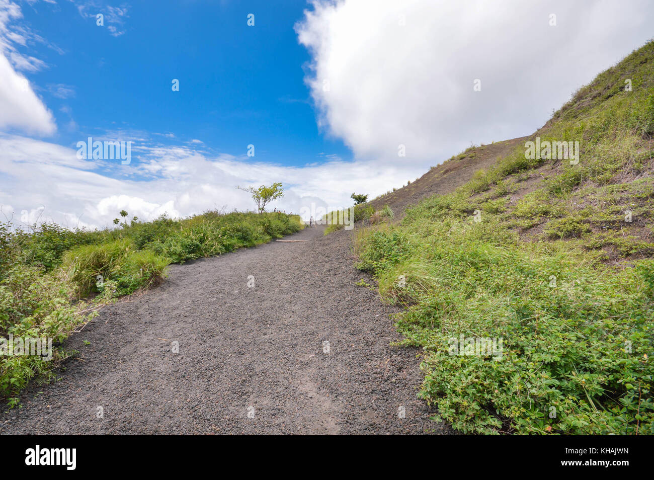 Green slopes of the dormant crater of Masaya Nindiri Vocano duo near Masaya, Nicaragua. Blue sky background Stock Photo
