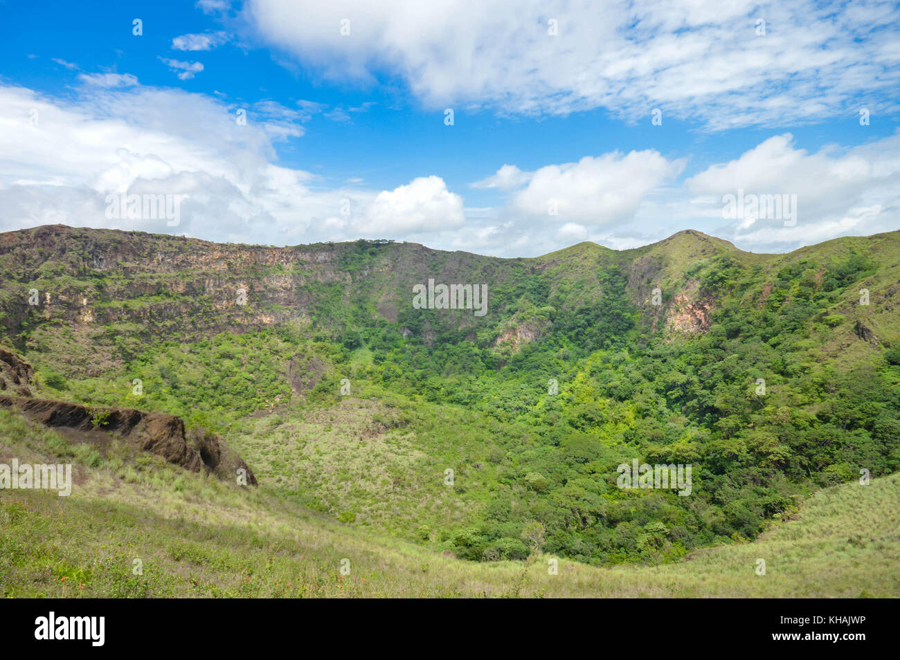 Green slopes of the dormant crater of Masaya Nindiri Vocano duo near Masaya, Nicaragua. Blue sky background Stock Photo