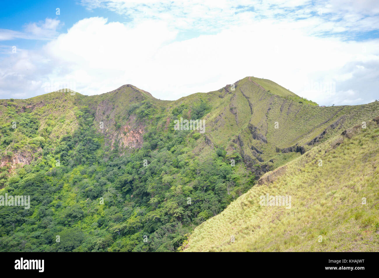 Green slopes of the dormant crater of Masaya Nindiri Vocano duo near Masaya, Nicaragua. Blue sky background Stock Photo