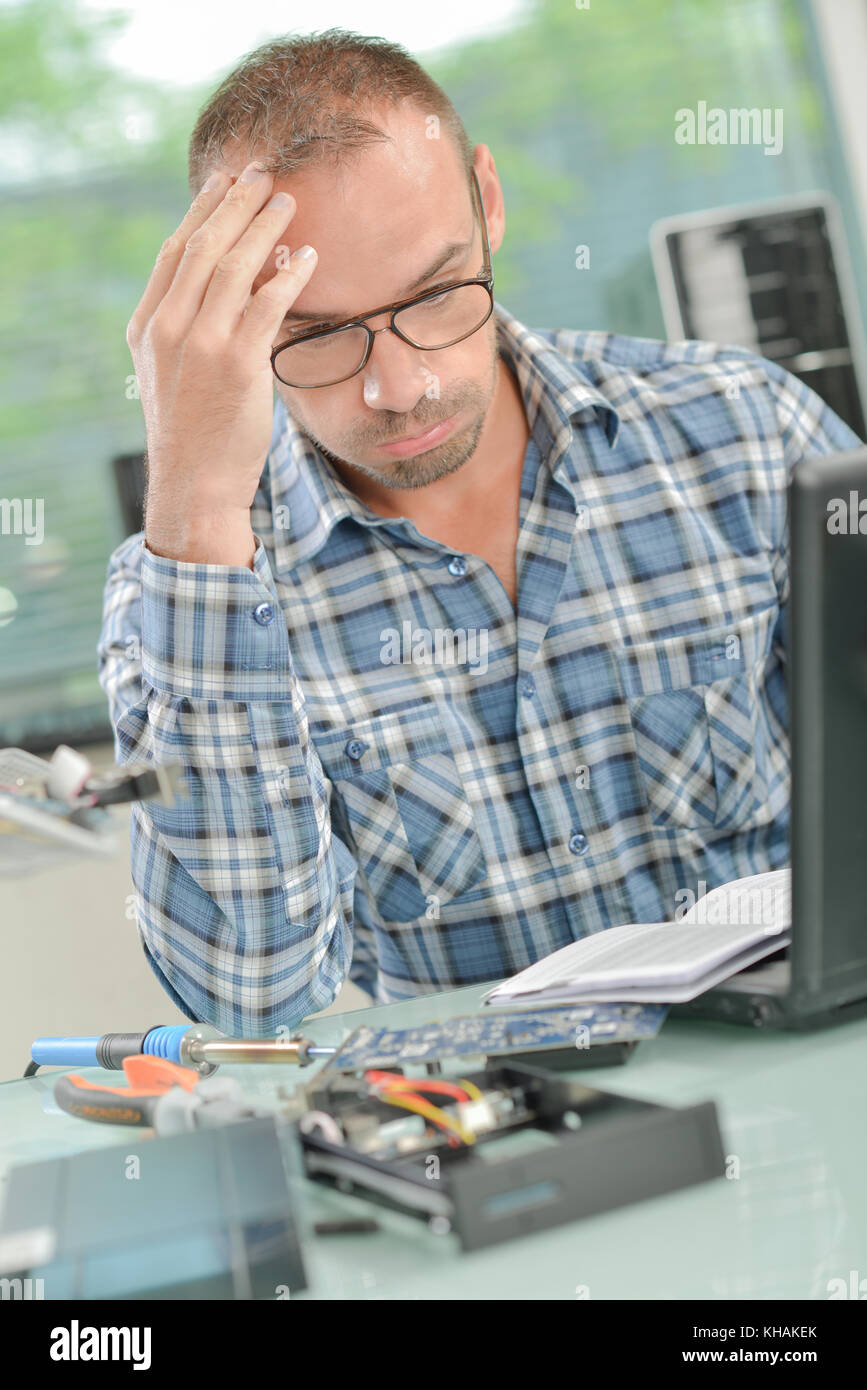 tired man with laptop thinking about failed project Stock Photo