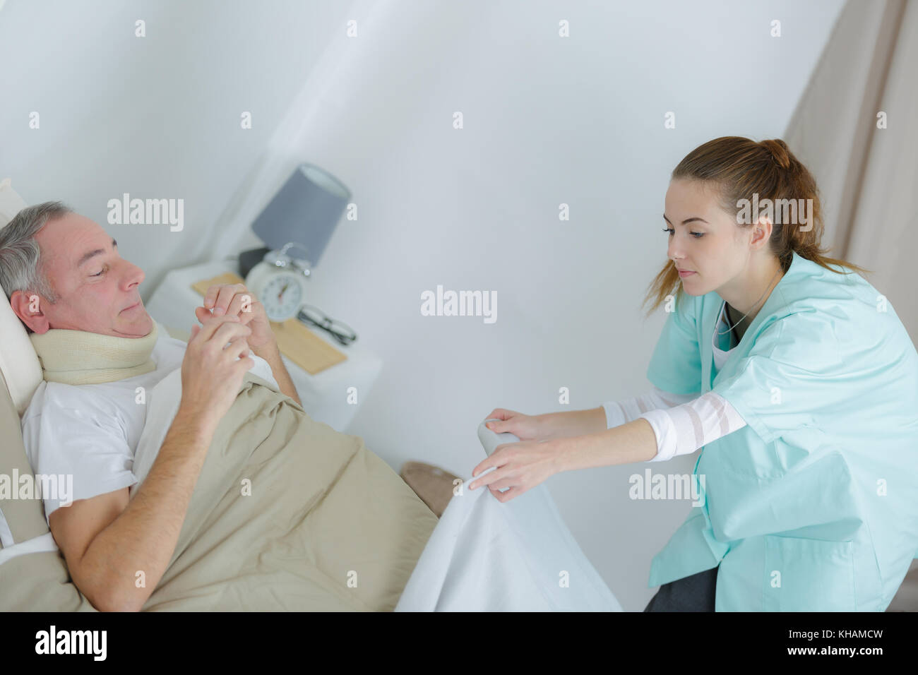 nurse putting a blanket on the patient Stock Photo 165578025 Alamy