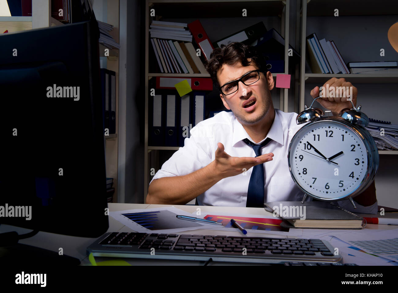 Man businessman working late hours in the office Stock Photo