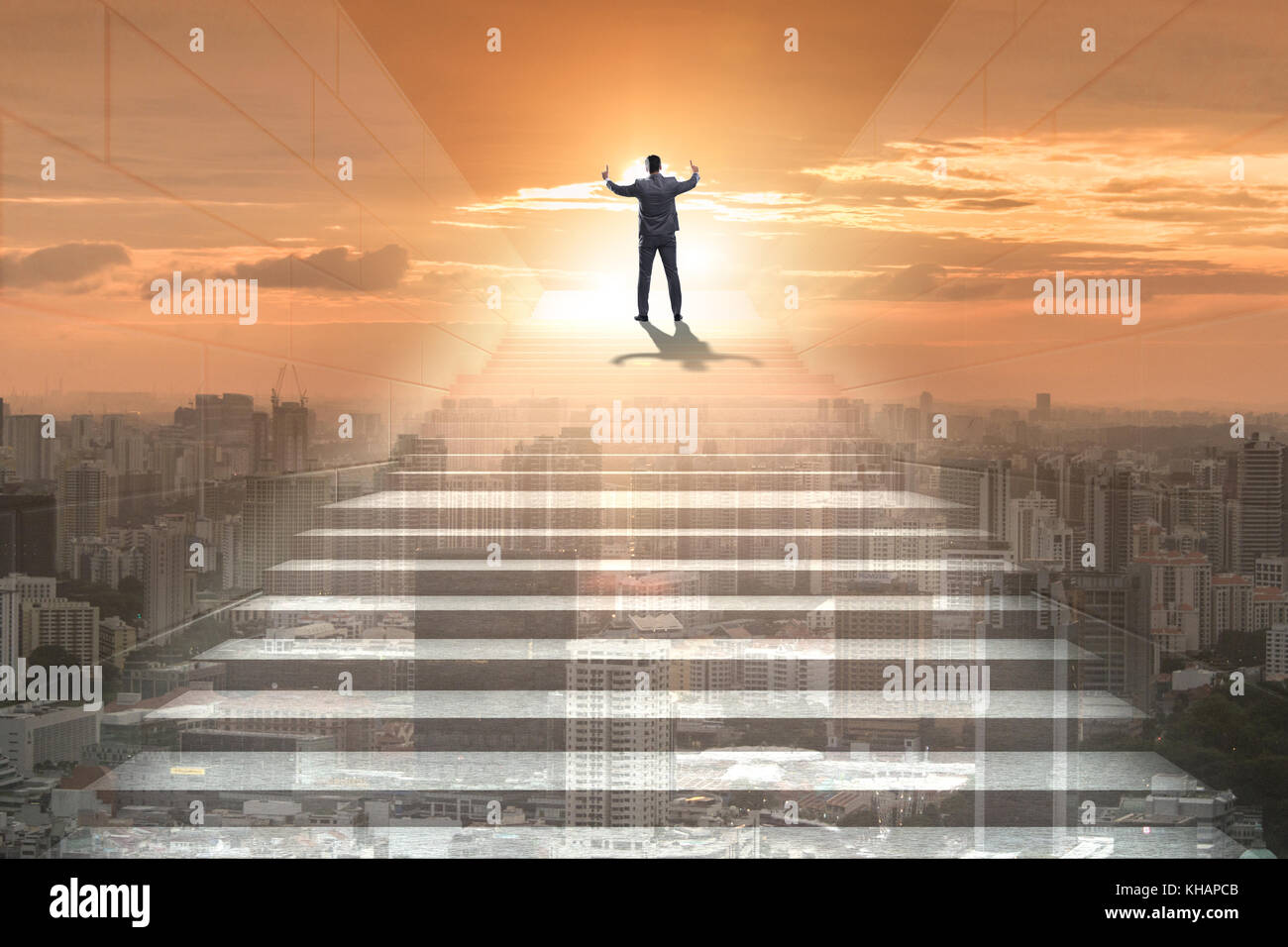 Businessman climbing up challenging career ladder in business concept ...