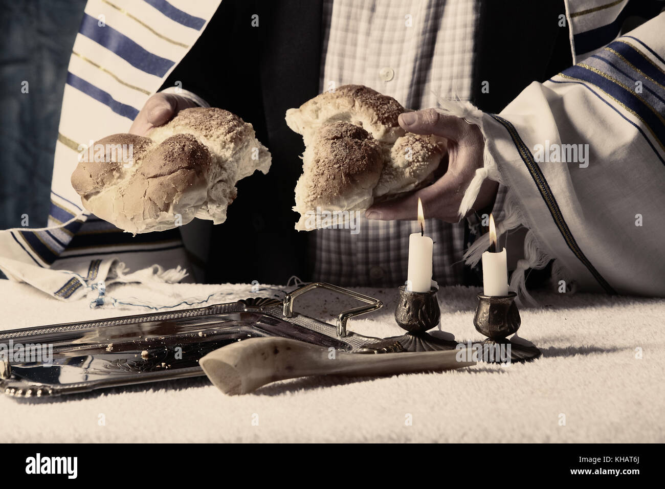 Sabbath kiddush, crystal candlesticks with lit candles, and challah