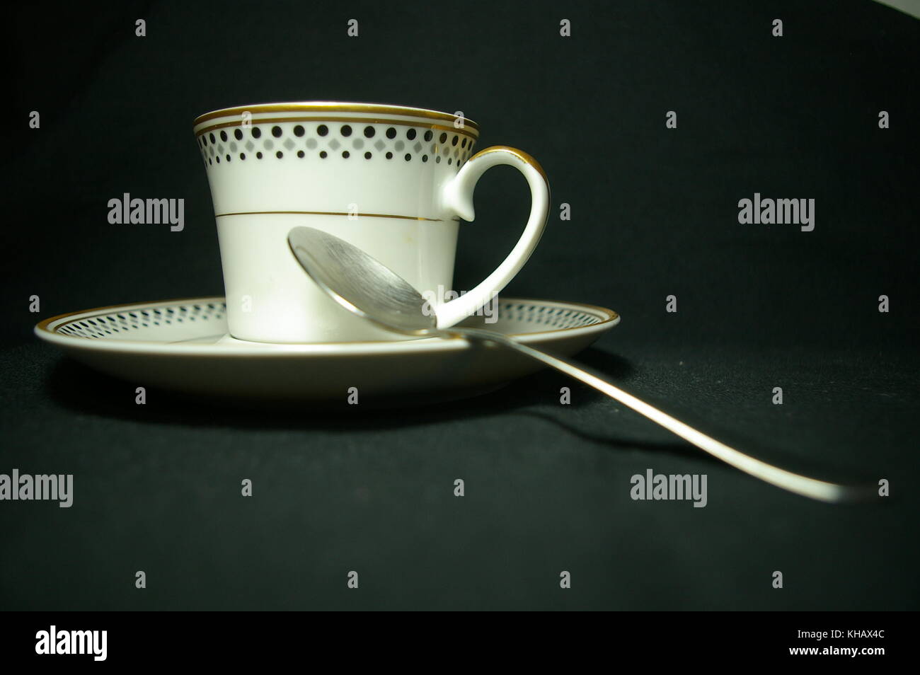 Cup and teaspoon blackbackground Stock Photo