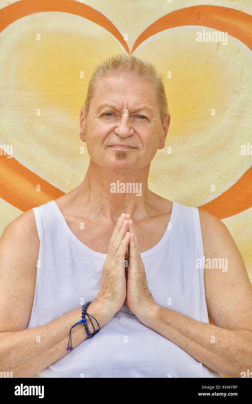 A senior caucasian man prays at silent retreat Stock Photo