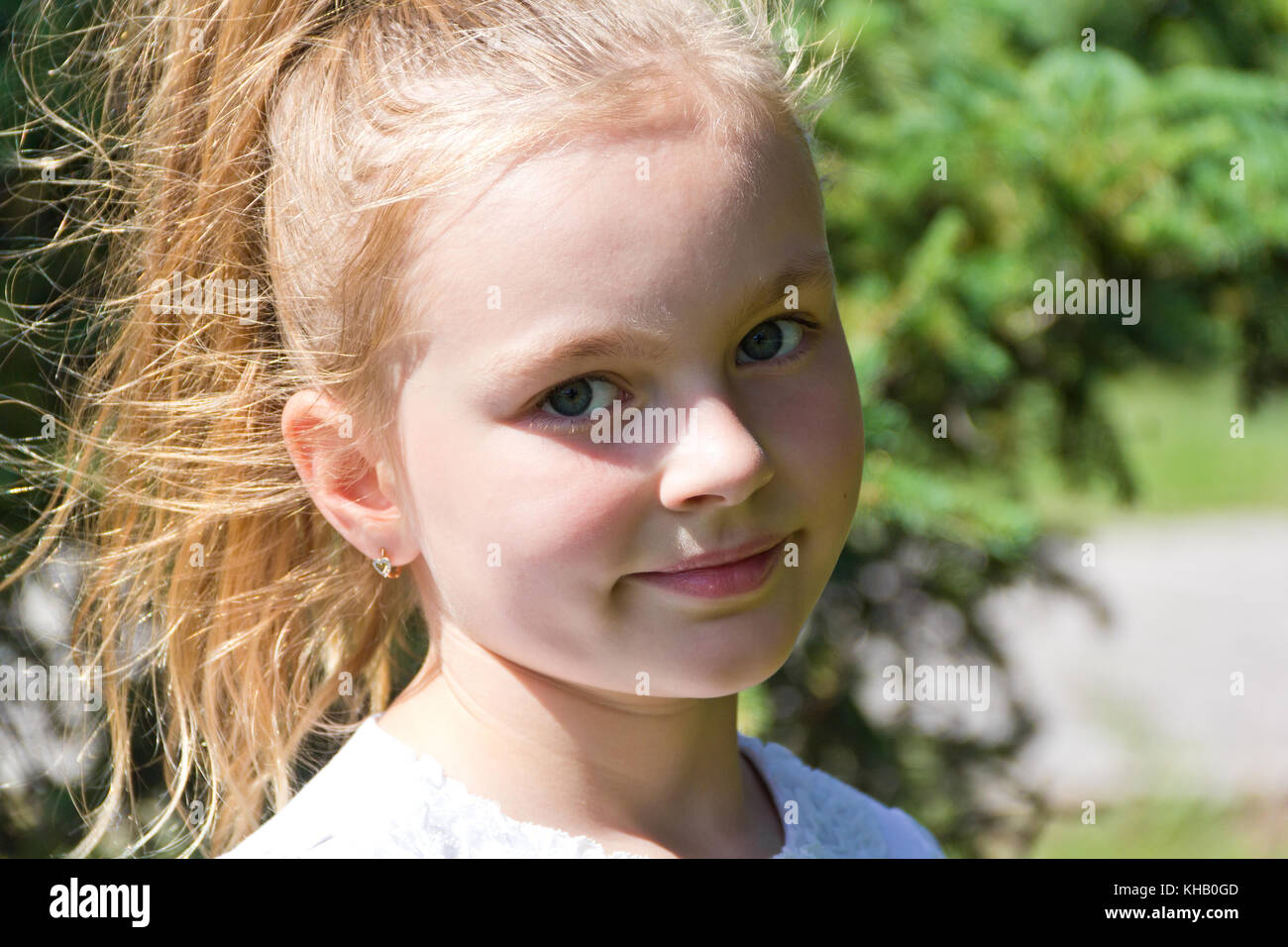 Cute girl with blond long hair and blue eyes Stock Photo - Alamy