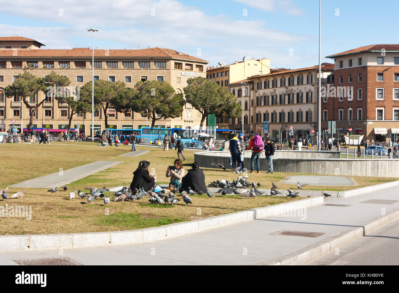 FLORENCE, ITALY - FEBRUARY 06, 2017:People relax on the grass near the railway station Firenze Stock Photo