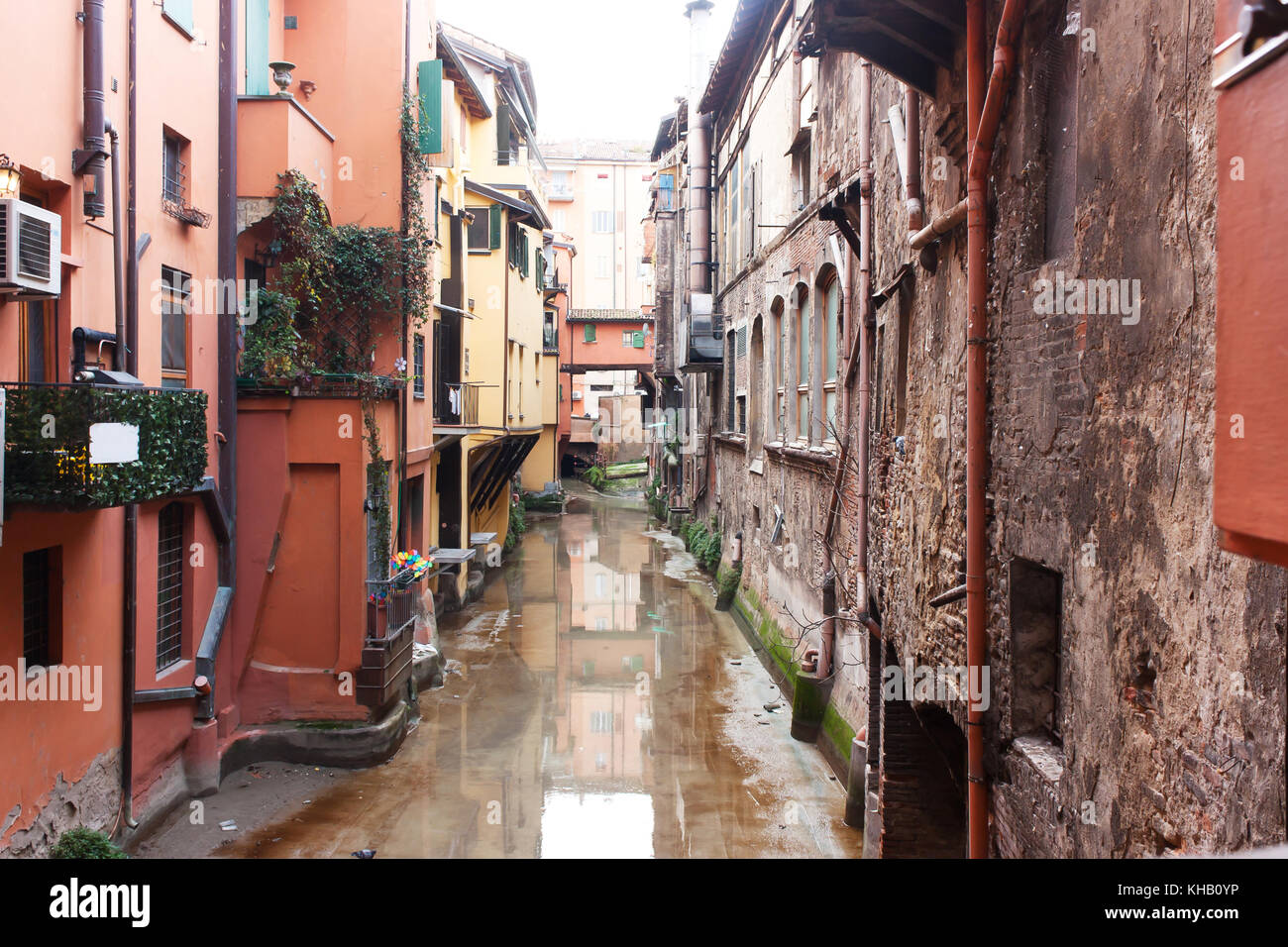 Old water canal hidden behind a window in Bologna  , Italy Stock Photo