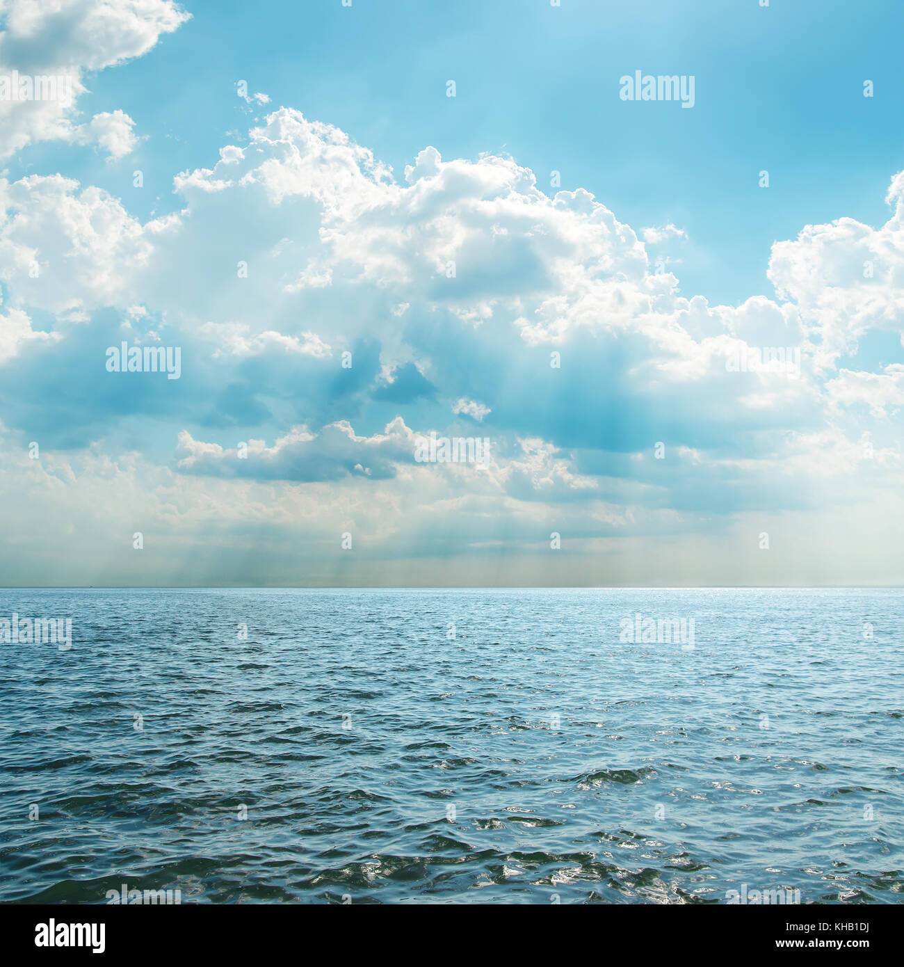 blue sea and cloudy sky over it Stock Photo - Alamy